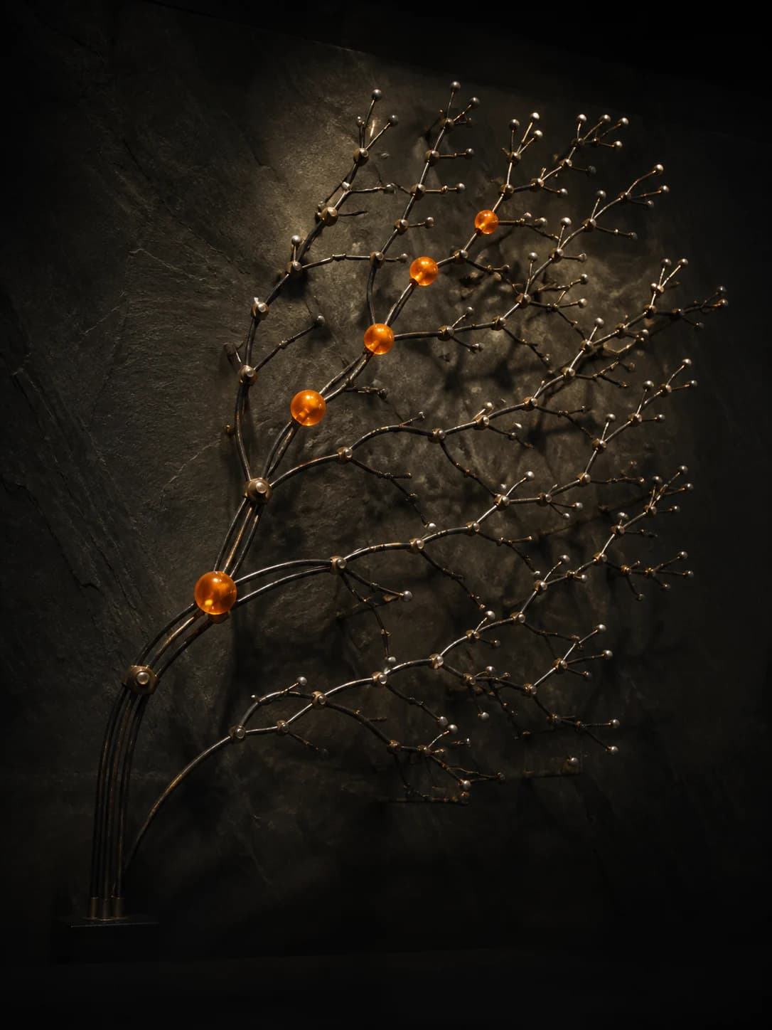 A branching metal search sculpture with one amber path highlighted